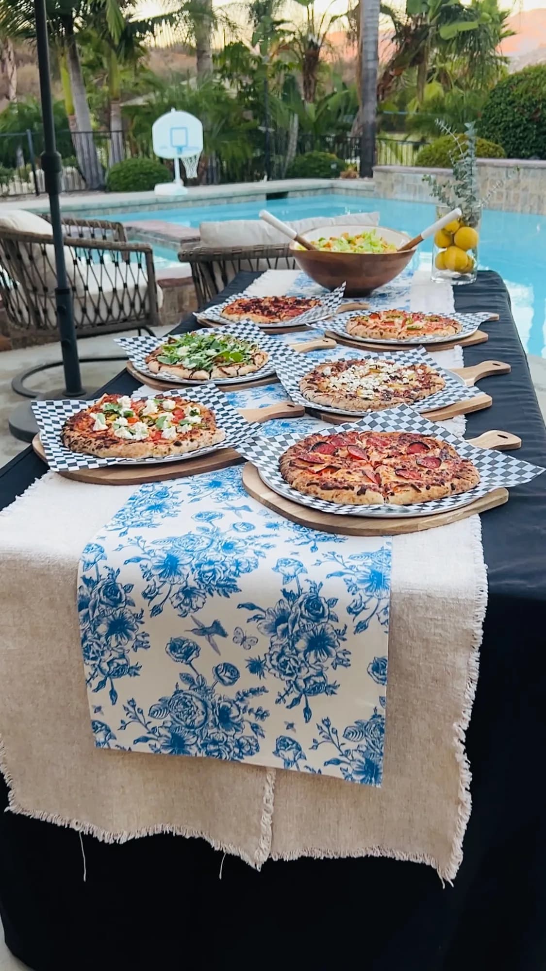 A long table of pizzas set out for guests at an event.